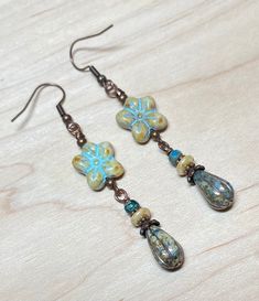 Everyday boho earrings perfect not only for spring and summer, but any time of year! These are created using Czech glass wild violet flower beads in beige with turquoise wash, opaque bluestone Czech glass teardrop beads with a platinum wash, small Czech tri-cut beads, small Czech disc beads, and antique copper accents.  Perfect for everyday, and make a lovely gift!  Total length of earrings, including the ear wire, is slightly over 2-1/2".    Thank you for shopping with The Lucie Collection! Adjustable Bohemian Flower Earrings, Adjustable Bohemian Drop Flower Earrings, Bohemian Dangle Flower Earrings For Pierced Ears, Hippie Dangle Earrings For Beach, Bohemian Green Teardrop Earrings With Ear Wire, Handmade Bohemian Flower Earrings With Czech Glass, Bohemian Czech Glass Dangle Flower Earrings, Bohemian Green Flower Earrings With Dangling Beads, Adjustable Bohemian Dangle Flower Earrings