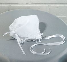 Designed so, when baby becomes a bride or groom, this bonnet converts to a hankerchief that the couple can use as a hankie on their wedding day or the mother of the bride or groom can carry it down the aisle. Beautiful wedding day tradition to start. Proudly made in the USA Measures 8.5" x 9" Fitted White Bonnet For Baptism, White Fitted Bonnet For Baptism, White Adjustable Hat For Baptism, White Adjustable Bonnet For Wedding, Elegant Bonnet For Wedding, One Size Fits Most, Elegant Wedding Bonnet - One Size Fits Most, Elegant Wedding Bonnet One Size Fits Most, White Adjustable Wedding Bonnet, Elegant Wedding Bonnet, One Size