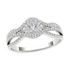 a white gold ring with two rows of diamonds on the band and a center diamond in the middle