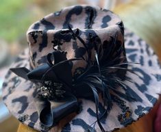 One of a kind custom made black and tan cheetah print felt fedora hat visor that can be worn for any occasion. Great for casual dressy occasions unique in style created with a burn out torching technique to achieve distressed, rustic, earthy moody textures. Adorned with a black vintage style brooch as an accent statement around the crown, black feathers and a black  satin necktie sculpted hat band which is one of our exclusive unique features on many of our creations. This derby style fedora mos Brown Hat Bands For Party In Fall, Brown Hat Bands For Fall Party, Western Style Brown Fedora For Party, Brown Western Fedora For Party, Handmade Elegant Fedora For Kentucky Derby, Custom Black Hat For Party, Handmade Party Fedora With Short Brim, Dressy Hats, Blank Hats