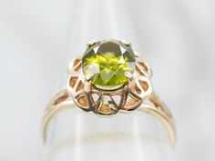 A gorgeous combination of polished gold and a lime green gemstone, these colors play beautifully off each other! The center is an oval-cut peridot, with great depth of color and lovely sparkle. Held in a scalloped filigree setting, the metal work around the stone gives this ring an antique old-world feel.Metal: 10K Yellow GoldGem: Peridot 2.02 CaratsGem Measurements: 6.9 x 8.9 mm, OvalRing Size: 6.50Marks: “B&F 10K” Stamped on the inside band Elegant Lime Green Oval Rings, Oval Peridot Green Jewelry, Oval Green Peridot Jewelry, Green Oval Peridot Jewelry, Lime Green Oval Jewelry For May Birthstone, Green Oval Filigree Ring, Oval Peridot Heirloom Jewelry, Green Oval Filigree Jewelry, Heirloom Peridot Oval Jewelry