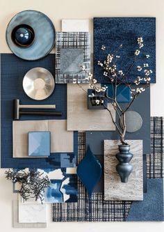 an arrangement of blue and gray items on display in a room with white wallpaper