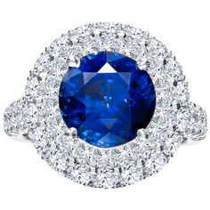 Absolutely beautiful in house crafted ring that showcases a 5 carat round royal blue sapphire that is surrounded by 2.63 carats total in round brilliant cut diamonds in double diamond halo as well as set in the split shank band. This piece makes a perfect addition to any event or even everyday wear. It is currently a size 6.5 but can be resized upon request. Diamond quality: F-G color, VS2 Clarity Sapphire Cocktail Ring, Blue Star Sapphire, Dream Party, Double Diamond, Halo Earrings Studs, Diamond Cocktail Rings, Cushion Cut Diamonds, Split Shank, Natural Blue Sapphire