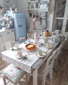 a dining room table with plates and cups on it