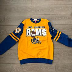 La Rams Crewneck Sweatshirt Size Small! Never Work! Oversized! Throwback Long Sleeve Tops For Game Day, Throwback Long Sleeve Top With Graphic Print, Throwback Long Sleeve Tops With Letter Print, Blue Tops With Ribbed Cuffs For Game Day, Blue Long Sleeve Team Spirit Sweatshirt, Yellow Crew Neck Top For Team Spirit, Yellow Crew Neck Top For Game Day, Blue Long Sleeve Sweatshirt With Team Spirit, Throwback Blue Crew Neck Top