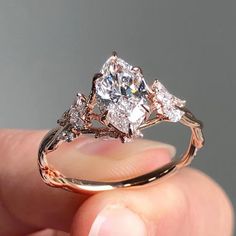 a person holding a diamond ring in their hand