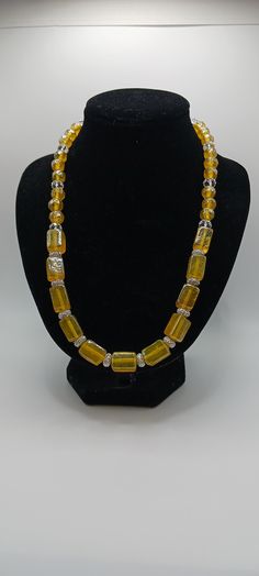 Ladies necklace with rectangle yellow glass beads and round yellow beads and round crystals.  Elastic Elegant Beaded Citrine Necklaces, Elegant Citrine Beaded Necklaces, Yellow Glass Beaded Necklace, Handmade Yellow Rectangular Jewelry, Gold Beaded Glass Crystal Necklaces, Yellow Single Strand Beads For Gifts, Rectangular Gold Beaded Jewelry, Gold Citrine Beaded Necklace For Gift, Handmade Yellow Glass Beaded Necklace