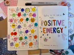 an open notebook with stickers on it and the words positive energy written in colorful letters