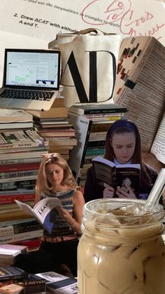 a jar filled with liquid sitting on top of a table next to books and laptops