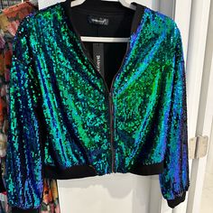 Sequin Light Weight Jacket, Green & Blue With Black Trim And Black Lining. It’s Brand New With Tags. Trendy Blue Party Outerwear, Trendy Blue Outerwear For Parties, Green Long Sleeve Outerwear For Night Out, Blue Spring Outerwear For Night Out, Blue Outerwear For Night Out In Spring, Blue Long Sleeve Party Outerwear, Blue Outerwear For Fall Party, Blue Sequined Outerwear For Party, Party Blue Sequined Outerwear