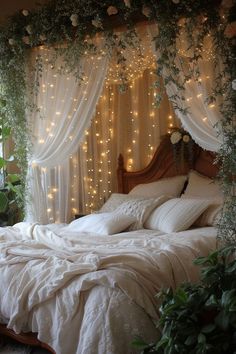 a bed with white linens and lights on the headboard is in front of a window