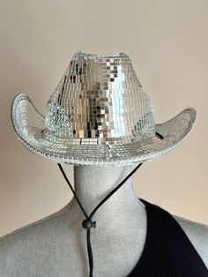 You'll be turning heads if you are heading to the a concert with this stunning Disco Ball  Cowboy  Hat .Add sparkle and glamour  to your outfit with this high quality disco cowboy hat made with thousands of  mosaic tiles. Measures about 15.75 in x 13.5 in x 5.5 in, hat circumference about 58 cm that fits most heads.   All hats are handmade ! A true statement piece that can be worn going to a concert, festival, rodeo, a bachelorette party or just need a stylish accessory  to complete your look.  Cowgirl Hat, Disco Hat , Performance, Festival, Rodeo, Fashion, Accessory, Statement Piece, Sparkle, Glamour,  Wearable Art, Bold and Bright Disco Cowboy Hat, Disco, Silver Disco Hat, Sparkly Cowgirl Hat,  Silver Cowboy Hat, Cowboy Disco Hat, Disco Ball Hat , Halloween Costume, Concert sparkly hats, Holographic Cowboy Hat, Luxury White Cowboy Hat For Western-themed Events, Custom Cowboy Hats Space, Trendy Party Bucket Hat, Trendy Bucket Hat For Party, Brimmed Party Costume Hats And Headpieces, Trendy Party Hat, One Size Fits Most, Trendy Party Hats One Size Fits Most, Western Adjustable Costume Hats For Parties