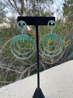 Green ombré hoops Length: 2.5 inches Pierced setting Sparkling Green Crystal Jewelry, Green Hoop Earrings For Party, Glamorous Green Jewelry With Rhinestones, Glamorous Green Rhinestone Jewelry, Green Hoop Jewelry For Party, Glamorous Green Rhinestone Earrings, Glamorous Green Metal Jewelry, Green Small Hoop Metal Earrings, Green Small Hoop Earrings