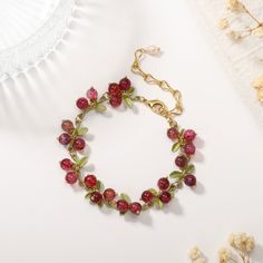 This Cranberry Agate Bracelet is the perfect accessory for the luxury-minded. From the stunning cranberry colour to the glossy agate stone, every element is carefully crafted for a sophisticated and exclusive look. Define your style with this timeless piece. DETAILS Plating: 18K Gold Materials: 18K Gold on Brass, Natural Stone Measurements: Length: 6.69"(17cm) + Extender: 2.76"(7.0cm) Weight: 15.43g There will be a little difference among different production batches of products due to the varia Elegant Red Agate Beaded Bracelets, Adjustable Ruby Bracelets Gift, Ruby Bracelets As A Gift, Elegant Agate Beaded Bracelets For Gift, Handmade Ruby Bracelets As Gifts, Handmade Adjustable Ruby Bracelet, Handmade Adjustable Ruby Bracelets, Elegant Natural Stones Charm Bracelet As Gift, Elegant Natural Stones Charm Bracelet For Gift