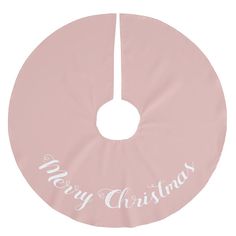 a pink christmas tree skirt with merry lettering