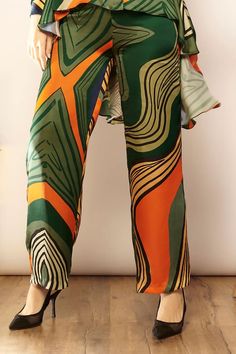 Green, orange high waisted pant with geometric print all over. - Aza Fashions Bold Multicolor Summer Pants, Bold High-waisted Summer Pants, Chic Bold Print Summer Pants, Bold High-waisted Summer Bottoms, Bold High-waisted Pants For Summer, Green Vibrant Print Summer Pants, Bold Straight Pants, Chic Abstract Print Pants For Spring, Spring Abstract Print Wide Leg Bottoms