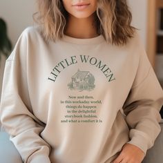 "Step into the world of classic literature with our enchanting Little Women sweatshirt inspired by the timeless charm of the novel. A perfect tribute to Louisa May Alcott's beloved masterpiece, this sweatshirt is a must-have for literary enthusiasts, English teachers, librarians, book nerds, and booktroverts who adore the magic of storytelling. Designed with meticulous attention to detail, the sweatshirt showcases the iconic Little Women, transporting you to the heartwarming world of the March sisters and their captivating adventures. The literary sweatshirt features the Alcott quote \"Now and then in this workaday world, things do happen in the delightful storybook fashion, and what a comfort it is.\"  This literary sweatshirt ensures a comfortable fit that will keep you warm during your Literary Long Sleeve Cotton Tops, Literary Long Sleeve Tops With Letter Print, Literary Shirts, English Teachers, Women Sweatshirt, Little Women, Bookish Gifts, Classic Literature, Book Nerd