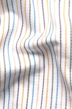 an image of a white and blue striped fabric with multicolored lines on it