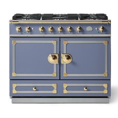 a blue and gold stove top oven with two burners on the front, and three brass knobs on the rear