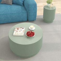 a living room with a blue couch, coffee table and vases on the floor