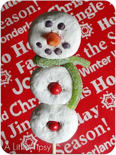 a snowman made out of doughnuts on top of a red tablecloth