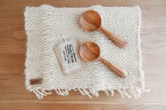 two wooden spoons sitting on top of a white towel