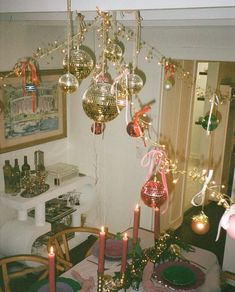 a dining room table with christmas decorations and lights on it's chandelier