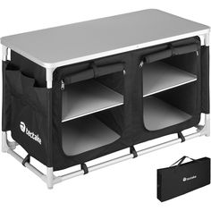 the back side of a black and white table with two storage bins on it