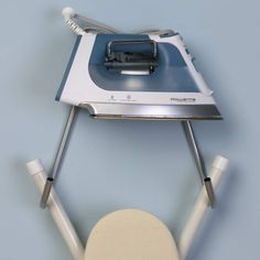 a white ironing board with an iron attached to it