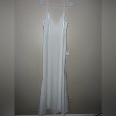 a white dress hanging on a hanger