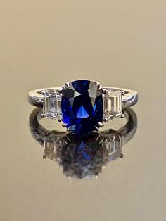 "DeKara Designs Collection Beautiful Modern/Art Deco Ceylon Blue Sapphire and Diamond Ring Metal- 90% Platinum, 10% Iridium Stones- Genuine Oval Ceylon/Sri Lanka Royal Blue Sapphire 3.75 Carats. Two Trapezoid Cut Diamonds F Color VS1 Clarity 1.09 Carats. Size-6 3/4. FREE SIZING Entirely Handmade, Classic and Timeless Art Deco Inspired Ceylon Oval Royal Blue Sapphire Diamond Engagement Ring. This ring is out of this world with the center Ceylon Sapphire being exceptional in quality, clarity, colo Luxury Oval Diamond Cut Sapphire Ring, Gia Certified Oval Sapphire Diamond Ring, Oval Diamond-cut Lab-created Sapphire Ring, Luxury Oval Lab-created Sapphire Ring, Gia Certified Oval Lab-created Sapphire Ring, Oval Diamond Cut Sapphire Ring Fine Jewelry, Oval Sapphire Three-stone Diamond Ring, Luxury Blue Three Stone Ring, Oval Sapphire Three Stone Diamond Ring