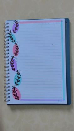 an open notebook with flowers and leaves on it