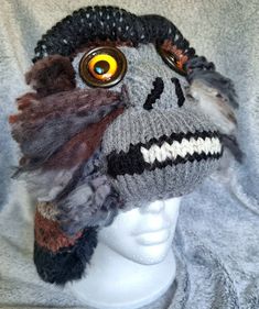 Each Bigfoot/Sasquatch hat is handmade--the combination of colors and yarn type, along with eye variations and expressions ensure that no two are exactly alike.  ITEM PICTURED IS WHAT YOU WILL RECEIVE (size in title).  Hats are warm and soft, with earflaps; each is individually named, using different world-wide terms for the Sasquatch. Sizes are suitable for adults and older children (smaller sizes can be requested).  As they are knit and do stretch, the average size fits most.  Hats come prewashed so there is no fear of shrinking.  Nearly all yarn is acrylic, but some have a small percentage of wool or other natural fiber. I have been interested in Sasquatch (the name I prefer) since childhood.  I believe that there are undiscovered species in this world, small and large, that have manage Quirky Handmade Winter Hats, Quirky Adjustable Cap, Adjustable Quirky Cap, Handmade Gray Hat One Size, Handmade Gray Hats One Size, Handmade Novelty Halloween Hat, Unique Handmade Hats, Handmade Unique Hats, Unique Handmade Hat One Size