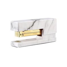 marble and gold stapler on white background