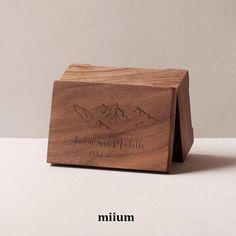 a wooden box with mountains engraved on it