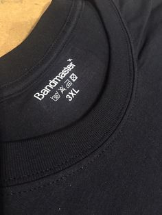 the back of a black t - shirt with white writing on it