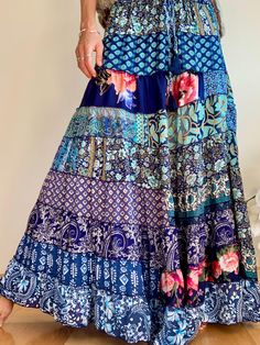 This is cute comfy maxi long skirt in hippie boho style made of soft flowy material in blue colors made patchwork of up cycled saree  Feels very light and flowy  Perfect modest skirt for everyday all year round, daily wear and occasions MEAESURE waist | elasticated 26-32"" length 39" MATERIAL *blended silk and polyester *no lining  CARE INSTRUCTIONS  * Wash in warm water * Hand wash recommended * Hang to dry  IMPORTANT NOTE  * Please note that colour shown on your monitor may vary from the colou Bohemian Flowy Maxi Skirt With Floral Print, Spring Bohemian Maxi Dress With Lined Skirt, Flowy Ruffled Festival Bottoms, Flowy Ruffled Skirt Bottoms For Festival, Bohemian Maxi Bottoms With Floral Print, Bohemian Maxi Length Bottoms With Floral Print, Bohemian Maxi Length Floral Print Bottoms, Bohemian Tiered Skirt With Floral Print, Bohemian Relaxed Skirt Maxi Dress For Spring