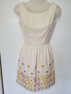 "Amazing vintage dress from the 70's! Vicky Vaughn Junior. Thick cream fabric. Beautiful geometric and floral embroidery! Zipper in the back. Mini Length. Cocktail Style. In Excellent Vintage Condition with no visible flaws. No size on tag, estimated size XS. Measurements: Bust: 32\" Waist: 24\" Hips: free Length: 32.5\"" Lined Cream Cotton Dresses, Cream Cotton Lined Dress, Cream Cotton Dress With Lining, Fitted Beige Embroidered Dress For Spring, Spring Vintage Dress With Embroidered Hem, Fitted Cream Dress With Floral Embroidery, Fitted Embroidered Off-white Dress, Fitted Embroidered Off White Dress, Fitted Off White Embroidered Dress