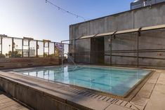 an empty swimming pool on the roof of a building