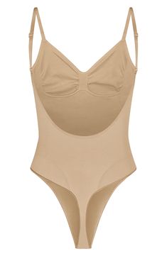 Sculpt your natural shape with a thong bodysuit that holds in your core and supports your chest flawlessly even in backless outfits. Sweetheart neck Adjustable straps 82% nylon, 18% spandex Machine wash, line dry Made in Turkey Stretch Backless Bodysuit With Built-in Bra, Sculpting Backless Swimwear With Built-in Bra, Shaping Backless Bodysuit With Built-in Bra, Backless Shapewear Leotard With Built-in Bra, Second-skin Bodysuit With Built-in Bra And Low Back, High Cut Leotard With Built-in Bra, Contoured Full Coverage Bodysuit With Built-in Bra, Full Coverage Sculpting Bodysuit With Built-in Bra, Beige Full Coverage Bodysuit With Built-in Bra