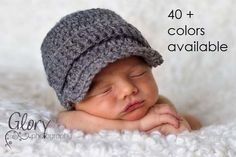 a newborn baby wearing a crochet hat with the words 40 + colors available