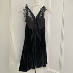 Nwot Gorgeous Velvet Dress Featuring Fabric Angel Wings In Back. In Excellent Condition, Never Worn. Features Double Straps, Bow In Front & Lace-Up Back. Women’s M But Would Definitely Fit A Small So Listing As Such. Polyester/ Spandex. From A Non-Smoking Home. Halloween Sleeveless Dress With Lace Trim, Black V-neck Dress For Costume Party, Black Gothic Mini Dress With Lace Trim, Black Mini Dress With Lace Trim For Halloween, Black Mini Dress With Lace Trim For Costume Party, Black Lace Trim Mini Dress For Costume Party, Halloween Night Out Dress With Lace Trim, Halloween Mini Dress With Lace Trim, Black Lace Trim Dress For Night