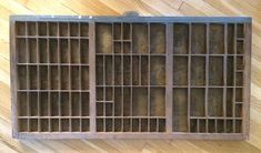 an old wooden jail cell with bars on the top and bottom, sitting on a hard wood floor