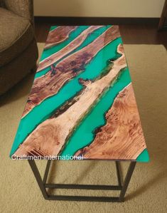 a table that is made out of wood and metal with blue paint on it, sitting in