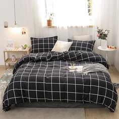 a black and white comforter set in a bedroom