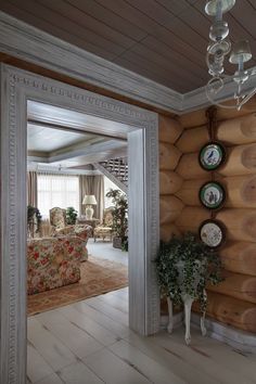 a living room filled with furniture and wooden walls