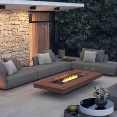 a living room with couches and a fire pit