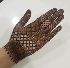 the hand is decorated with intricate designs