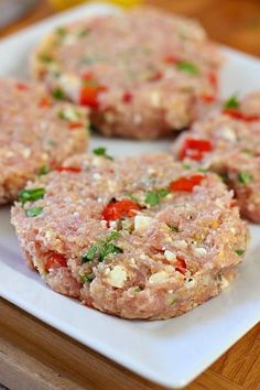 some meat patties are on a white plate