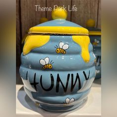 there is a blue bowl with yellow bees on it and the words honey painted on it